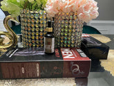 Anaconda oil male enhancement product bottle displayed with packaging on a table next to decorative flowers